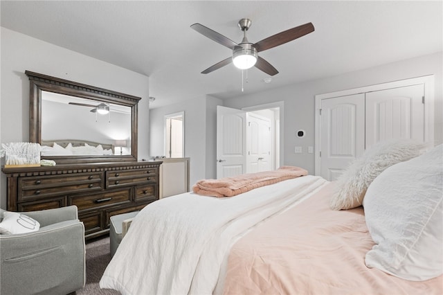 bedroom with ceiling fan, carpet, and a closet