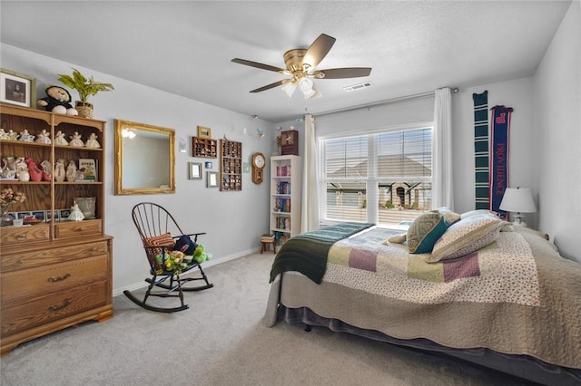 bedroom featuring ceiling fan and carpet