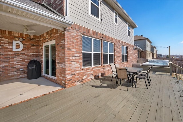 wooden terrace featuring a patio and ceiling fan