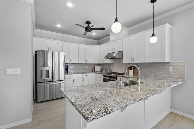 kitchen with sink, appliances with stainless steel finishes, white cabinetry, hanging light fixtures, and kitchen peninsula