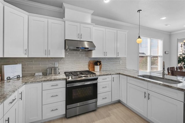 kitchen with stainless steel range with gas cooktop, pendant lighting, white cabinetry, sink, and ornamental molding