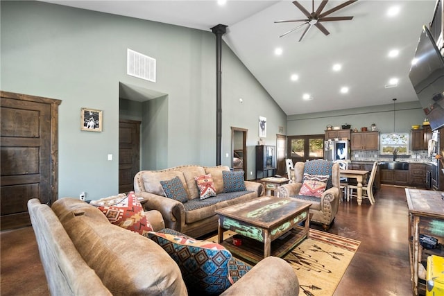 living room with high vaulted ceiling, recessed lighting, visible vents, a ceiling fan, and finished concrete flooring