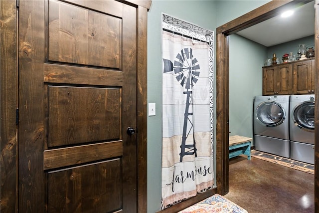 laundry room with separate washer and dryer and cabinet space