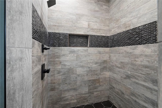 bathroom with a tile shower