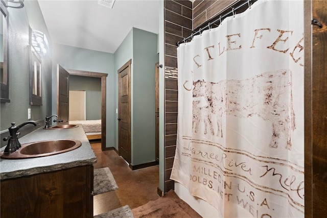 full bath featuring double vanity, concrete floors, a sink, and visible vents