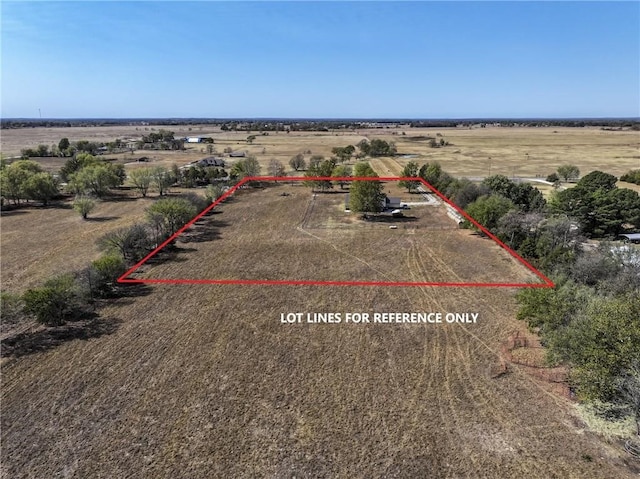 birds eye view of property with a rural view