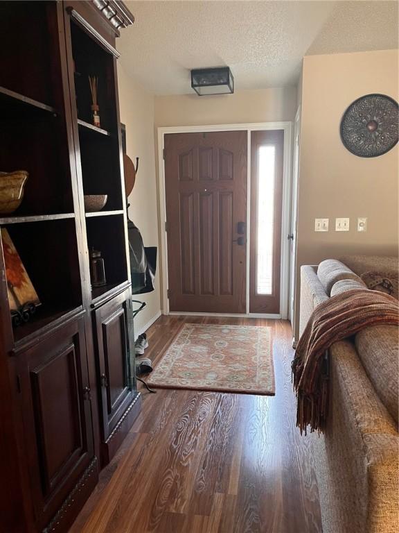 entryway featuring dark hardwood / wood-style floors and a textured ceiling