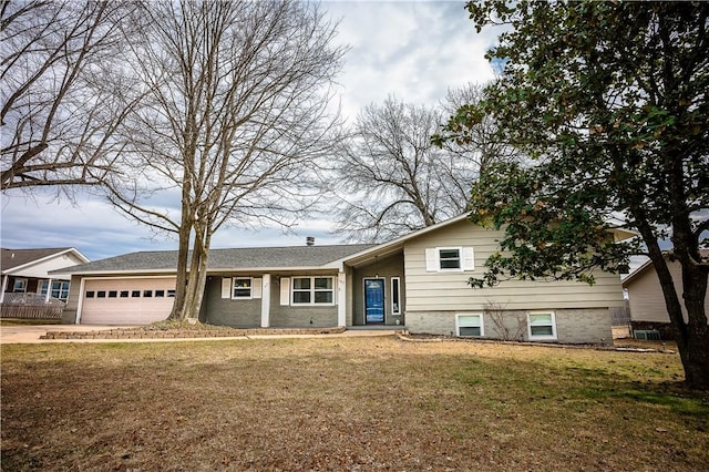 split level home with a garage and a front yard