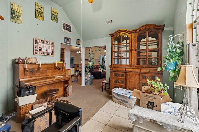 office space featuring high vaulted ceiling, light colored carpet, and ceiling fan