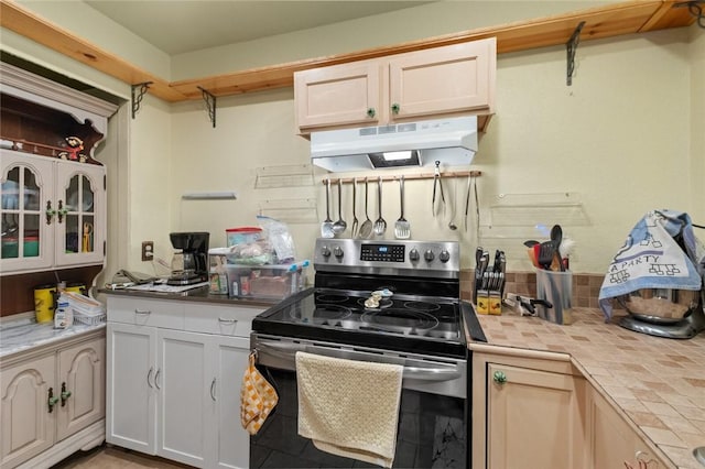 kitchen featuring tasteful backsplash, stainless steel electric range oven, tile countertops, and white cabinets