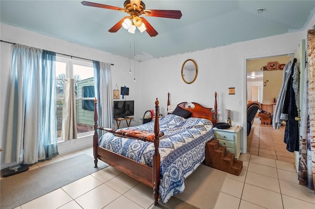 tiled bedroom featuring ceiling fan and lofted ceiling