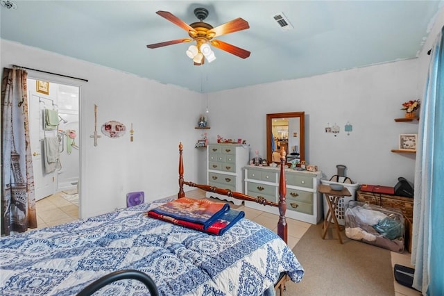 bedroom featuring connected bathroom, light tile patterned floors, and ceiling fan