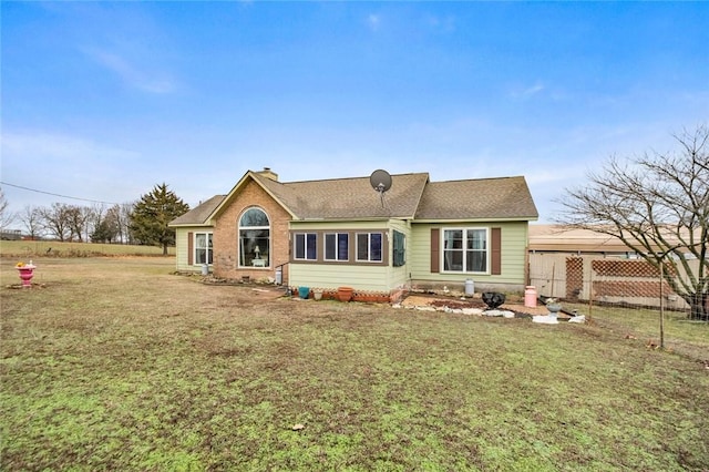 rear view of property with a lawn