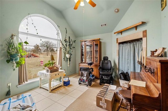 office featuring plenty of natural light, high vaulted ceiling, ceiling fan, and light tile patterned floors