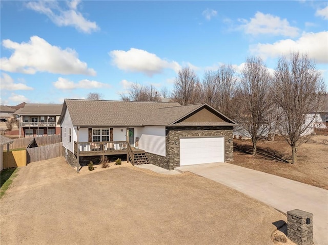 single story home featuring a garage and a wooden deck