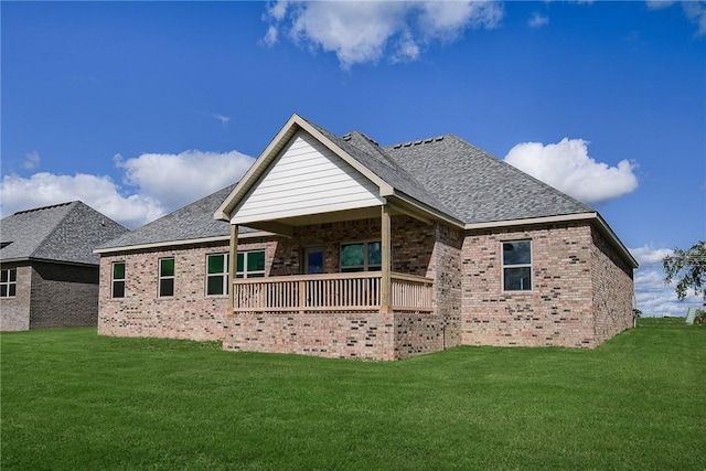 back of house with a deck and a lawn