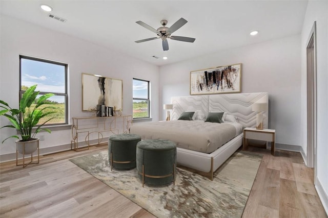 bedroom with light hardwood / wood-style flooring and ceiling fan