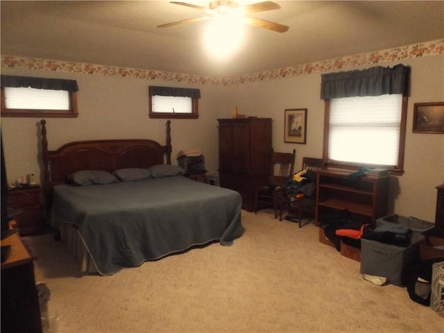 bedroom featuring ceiling fan and light colored carpet