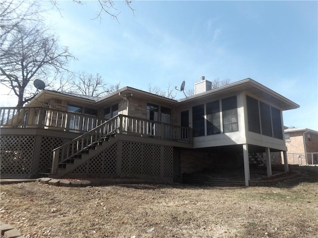 back of property featuring a sunroom and a deck