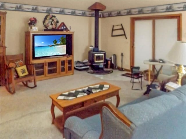 carpeted living room with a wood stove