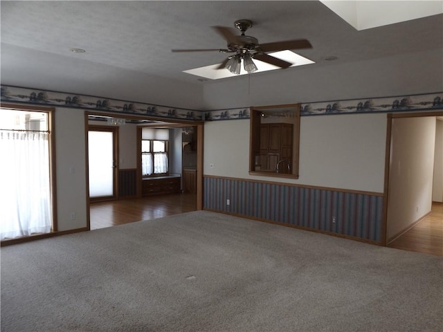 82 Baypoint Dr, Mountain Home, AR 72653 - carpeted spare room featuring a ceiling fan, wainscoting, and wood finished floors