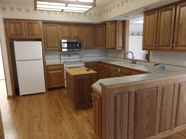 82 Baypoint Dr, Mountain Home, AR 72653 - kitchen featuring white appliances, light wood-style flooring, wood counters, a sink, and brown cabinets