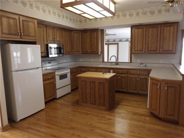 82 Baypoint Dr, Mountain Home, AR 72653 - kitchen with brown cabinetry, white appliances, a sink, and ceiling fan