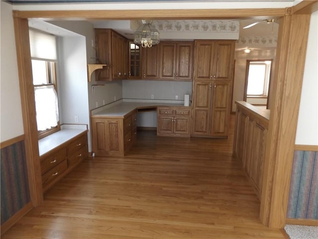 82 Baypoint Dr, Mountain Home, AR 72653 - kitchen featuring brown cabinets, glass insert cabinets, a wealth of natural light, and light wood-style floors