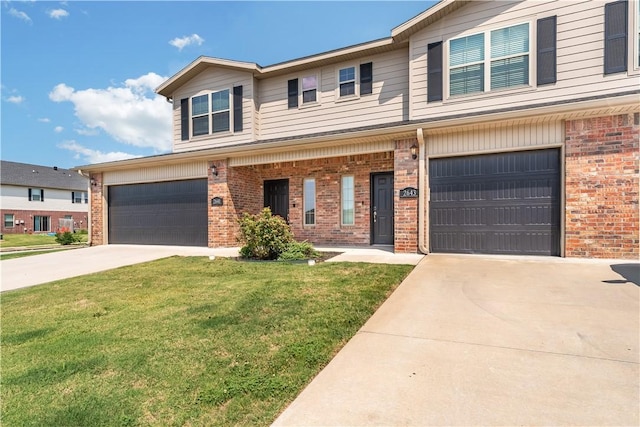 view of front of property with a garage and a front lawn