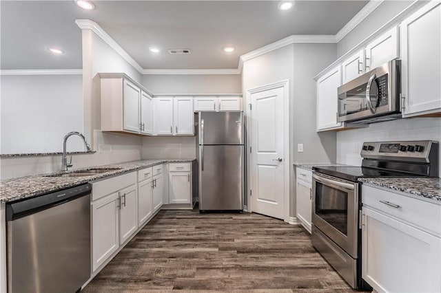 2643 S Kilimanjaro Way, Rogers, AR 72758 - kitchen with stainless steel appliances, crown molding, light stone countertops, white cabinetry, and recessed lighting