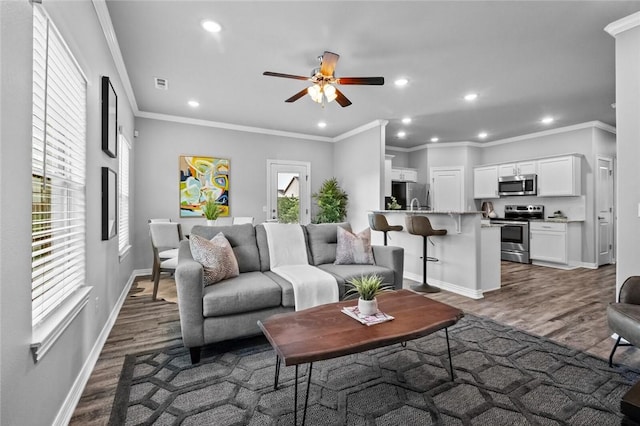 2643 S Kilimanjaro Way, Rogers, AR 72758 - living room featuring dark wood-type flooring, recessed lighting, ceiling fan, and crown molding