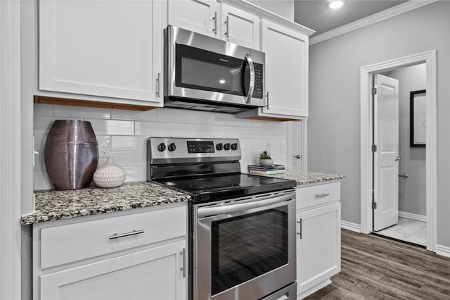 2643 S Kilimanjaro Way, Rogers, AR 72758 - kitchen with appliances with stainless steel finishes, ornamental molding, white cabinetry, backsplash, and light stone countertops