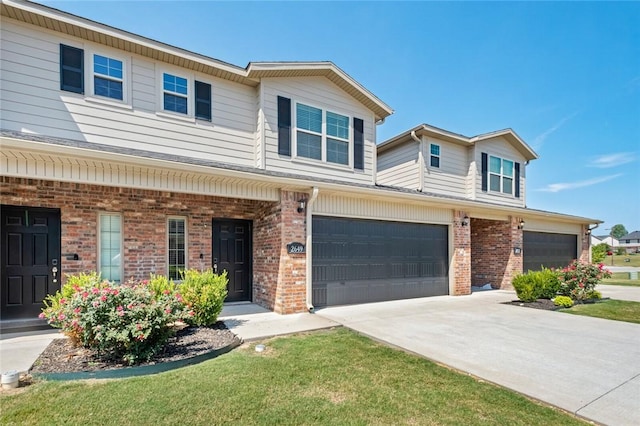 view of property featuring a porch, a garage, and a front yard