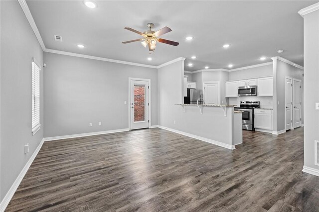 2649 W Everest Ave, Rogers, AR 72758 - unfurnished living room featuring ceiling fan, recessed lighting, dark wood finished floors, and ornamental molding