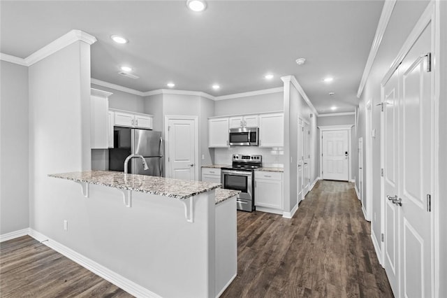 2649 W Everest Ave, Rogers, AR 72758 - kitchen with appliances with stainless steel finishes, a peninsula, a breakfast bar, light stone counters, and white cabinets