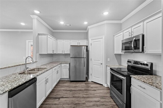 2649 W Everest Ave, Rogers, AR 72758 - kitchen with appliances with stainless steel finishes, white cabinets, dark wood-style floors, ornamental molding, and recessed lighting