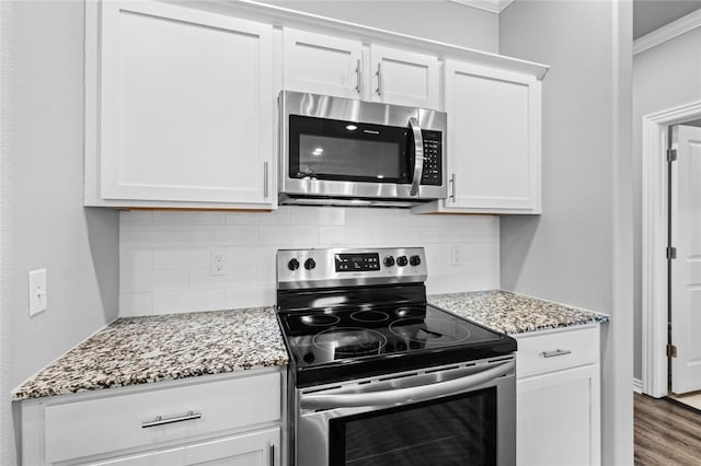 2649 W Everest Ave, Rogers, AR 72758 - kitchen with stainless steel appliances, ornamental molding, decorative backsplash, light stone countertops, and white cabinets
