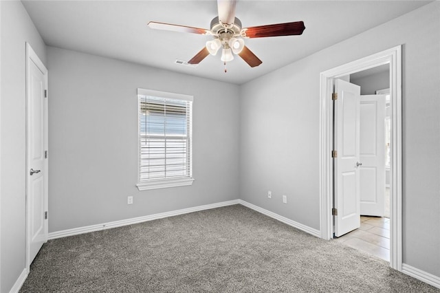 2649 W Everest Ave, Rogers, AR 72758 - unfurnished bedroom featuring carpet floors, connected bathroom, and a ceiling fan