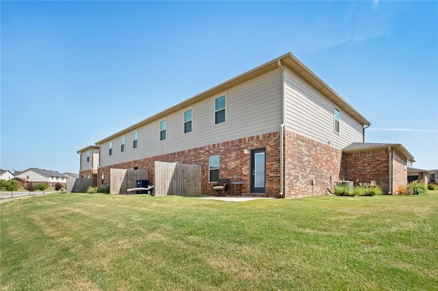 2649 W Everest Ave, Rogers, AR 72758 - rear view of house with brick siding and a lawn