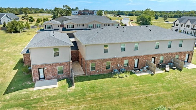 2649 W Everest Ave, Rogers, AR 72758 - rear view of house with a patio area, brick siding, a lawn, and a residential view