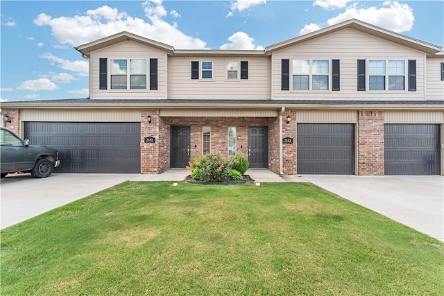 view of property with a garage and a front yard