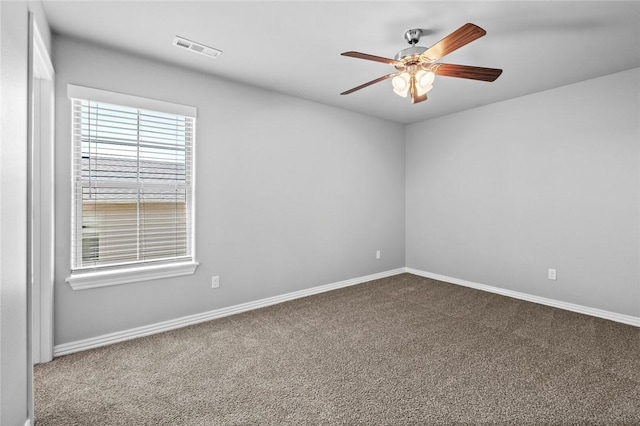 carpeted spare room with ceiling fan