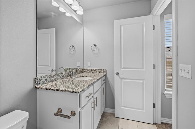 bathroom featuring vanity, toilet, and tile patterned flooring