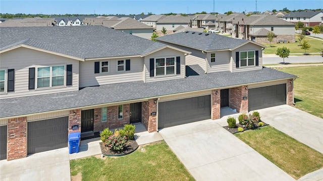 2633 S Kilimanjaro Way, Rogers, AR 72758 - view of front of home with brick siding, concrete driveway, a garage, and a residential view