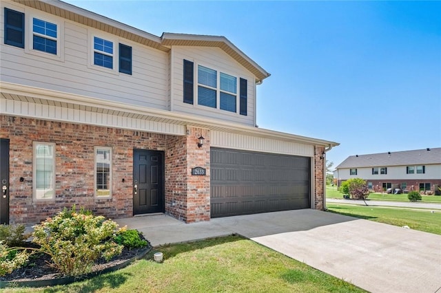 view of front of house with a garage and a front lawn