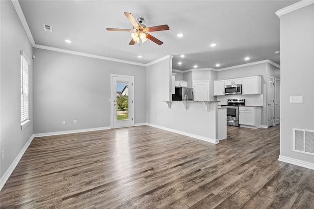 unfurnished living room with dark wood-type flooring, ceiling fan, and ornamental molding