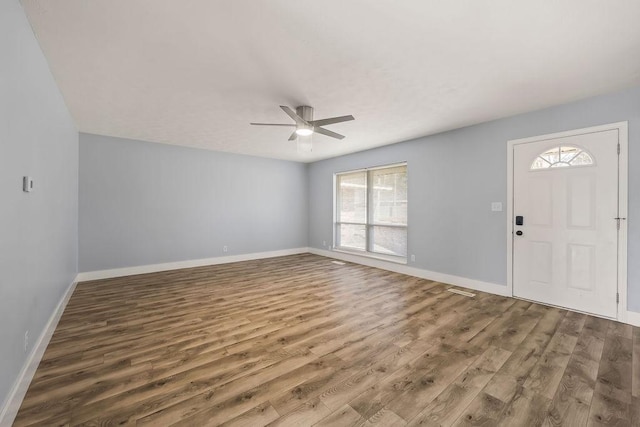 entrance foyer featuring wood finished floors, ceiling fan, and baseboards
