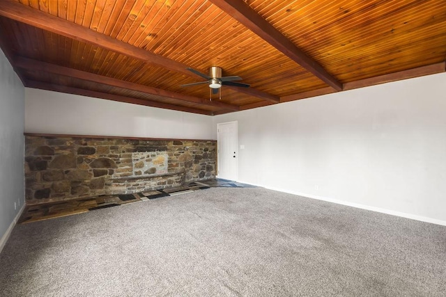 empty room featuring beam ceiling, ceiling fan, wooden ceiling, carpet floors, and baseboards