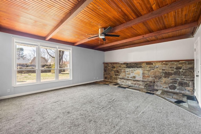 unfurnished living room featuring wooden ceiling, beam ceiling, carpet floors, ceiling fan, and baseboards