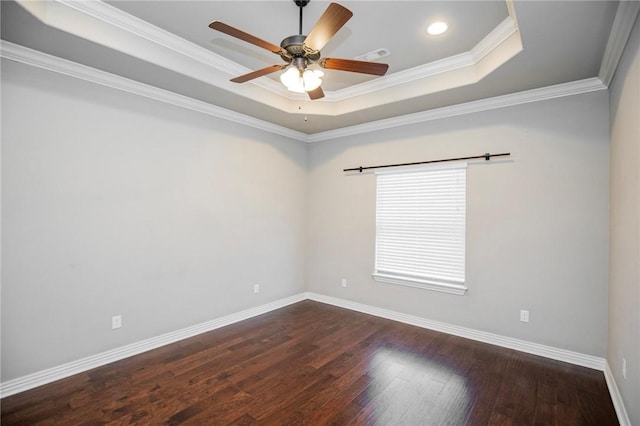 unfurnished room featuring dark wood-type flooring, ornamental molding, a raised ceiling, and ceiling fan